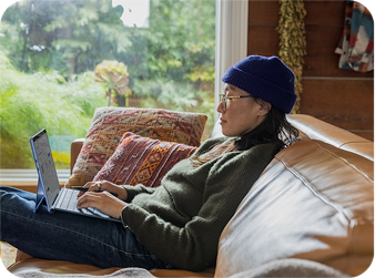 woman on couch with laptop
